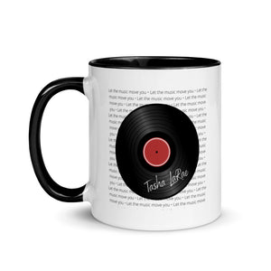 11 oz white coffee mug with a black handle with black vinyl record graphic with Tasha LaRae autograph and the words Let the music move you repeated in the background. The design is on both sides of the mug.